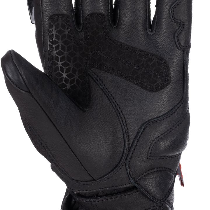 Alt Text: Close-up of a black motorcycle glove showing the textured palm detail and protective padding.