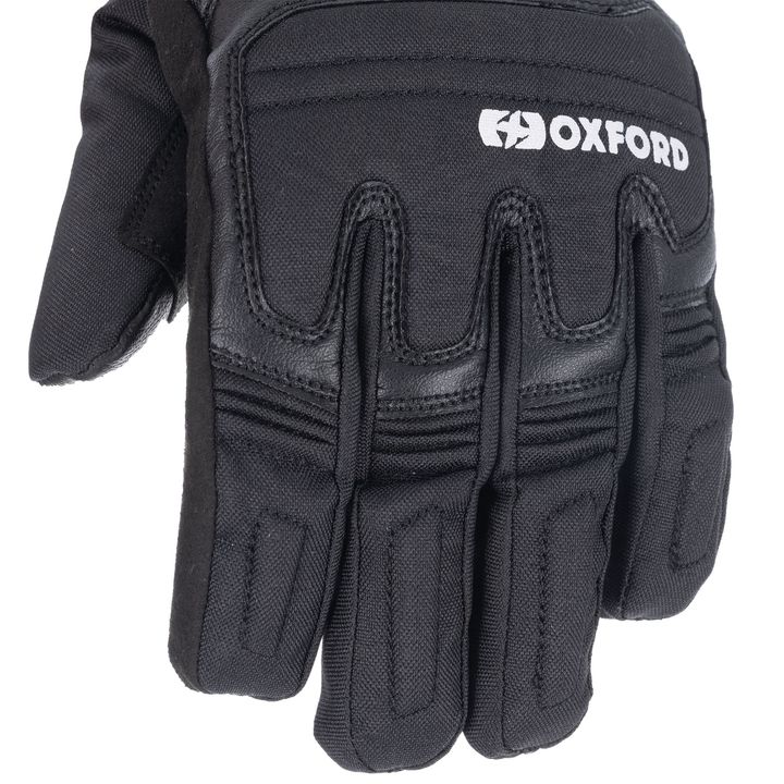 A close-up of a black Oxford motorcycle glove showing the brand logo and protective padding details on the fingers and back of the hand.