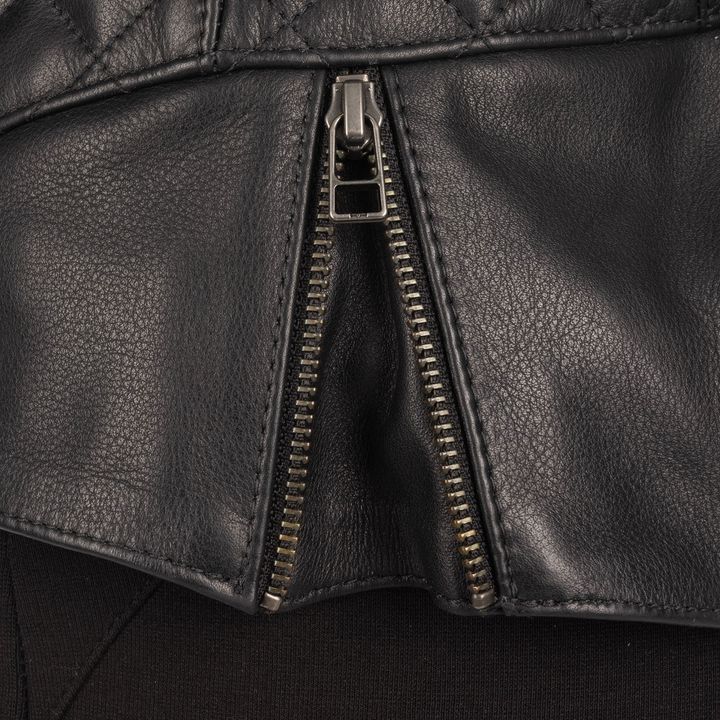 A close-up of a black leather jacket with a partially unzipped metal zipper.