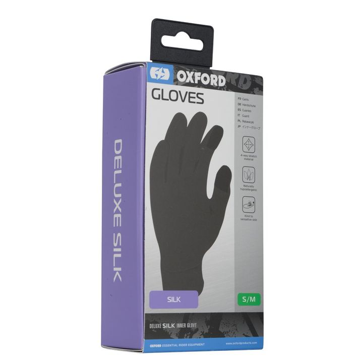 A package of Oxford Deluxe Silk gloves with a depiction of a black glove on the front, marked as silk with a size S/M, and icons indicating features such as 4-way stretch, naturally hypoallergenic, and kind to sensitive skin.