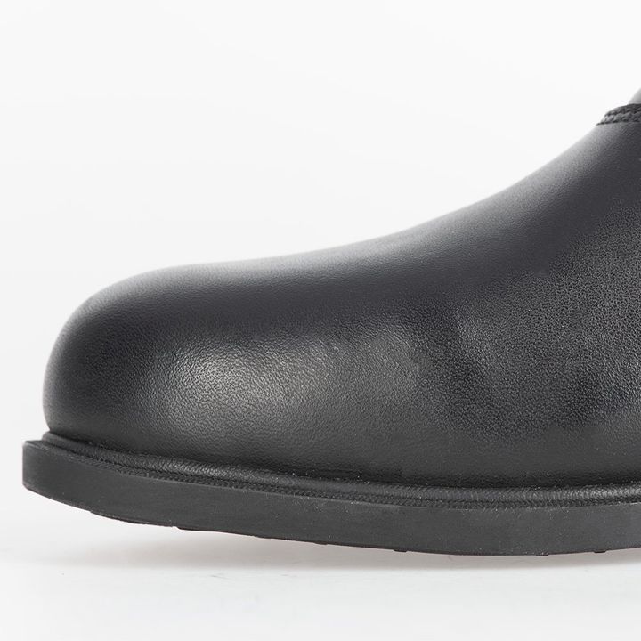 Close-up of a black leather shoe on a white background, showing the toe box and the beginning of the sole.