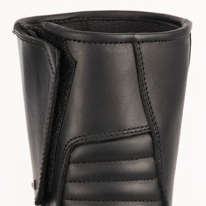 Close-up of the upper part of a black leather boot showing detailed stitching and texture.