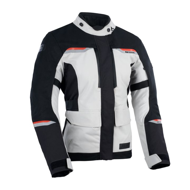 Mondial 2.0 Women's Jacket A motorcycle jacket in black, white, and gray with red accents, featuring plenty of utility pockets, Velcro straps for fitting adjustments, and protective padding on the shoulders and elbows.