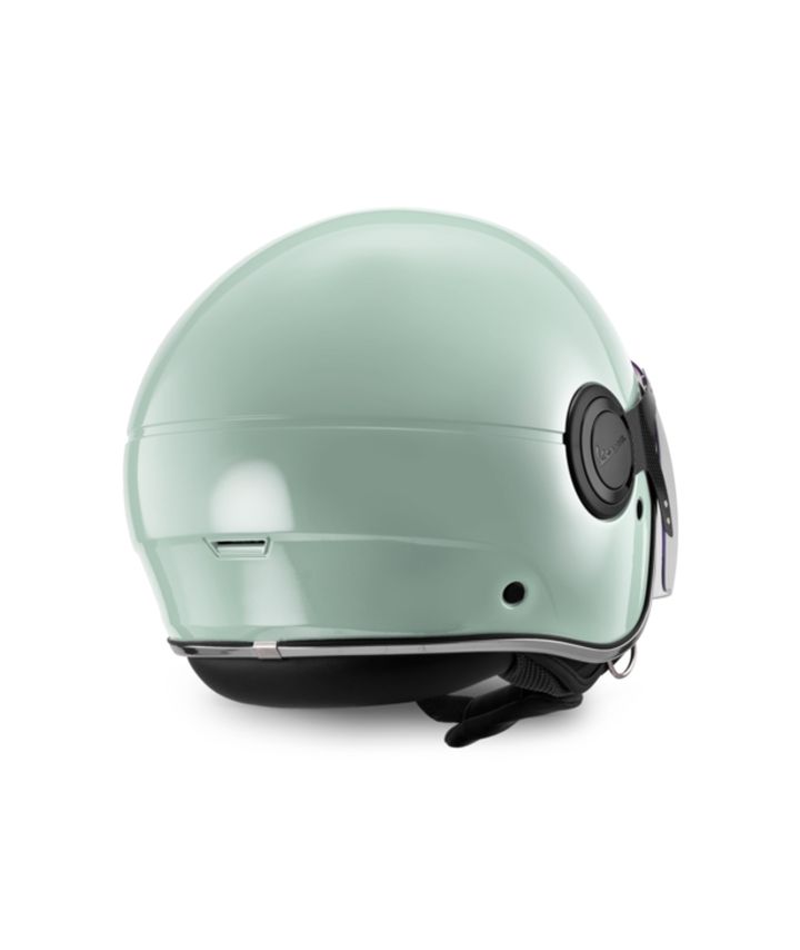 A mint green motorcycle helmet with a closed visor and black strap on a white background.