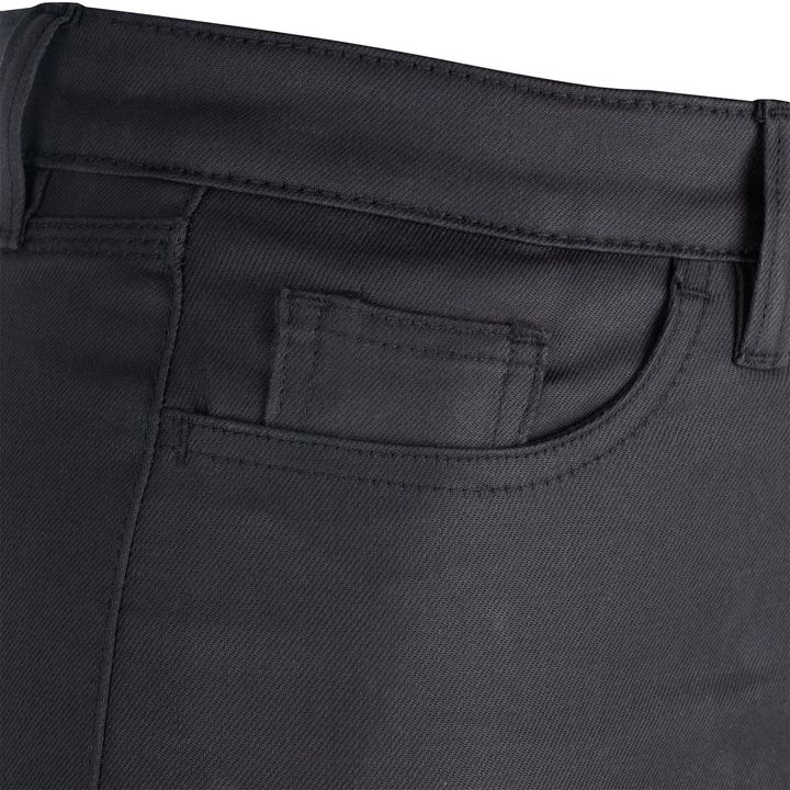 Close-up of a black textile material with a pocket detail, featuring stitching and a waistband, likely part of a piece of clothing such as trousers or a skirt.