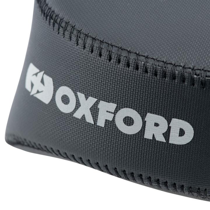 Close-up of a black textile product with the word "OXFORD" and a logo, featuring detailed stitching along the edge.