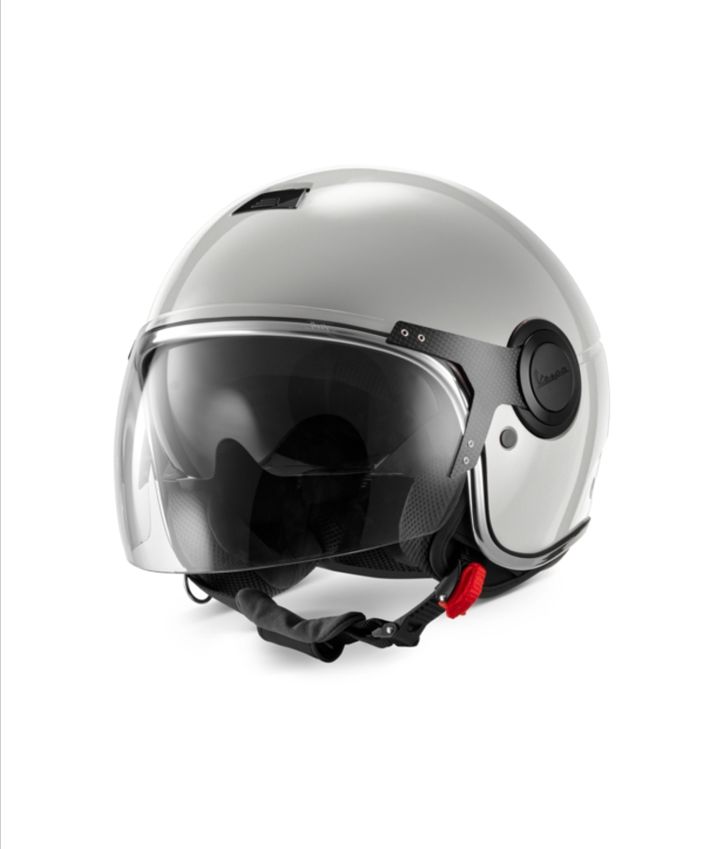 A silver motorcycle helmet with a clear visor and black padding, featuring a prominent logo on the side, isolated on a white background.