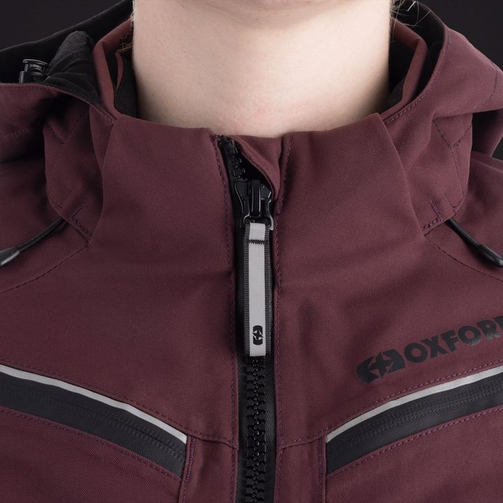 Close-up of a maroon jacket with a partially unzipped black and silver zipper and a visible 'OXFORD' brand logo.