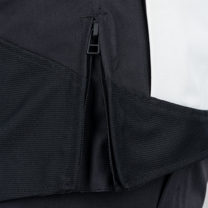 Close-up of a black jacket zipper partly open against a white background.