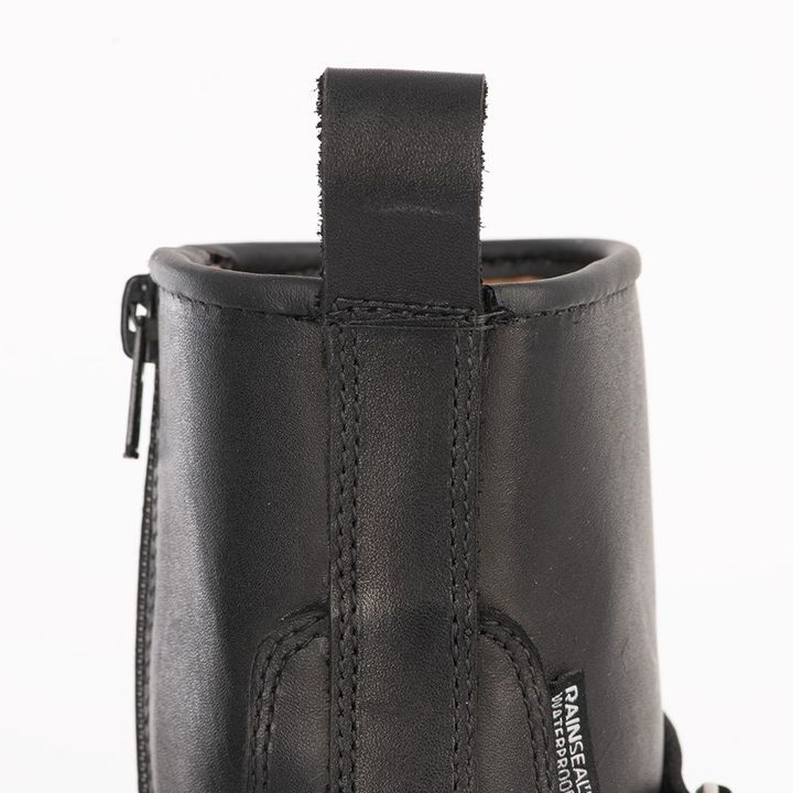 Close-up of the back of a black leather boot showing a pull tab, stitched seams, and a side zipper with a "RAINSEAL Waterproof" label.