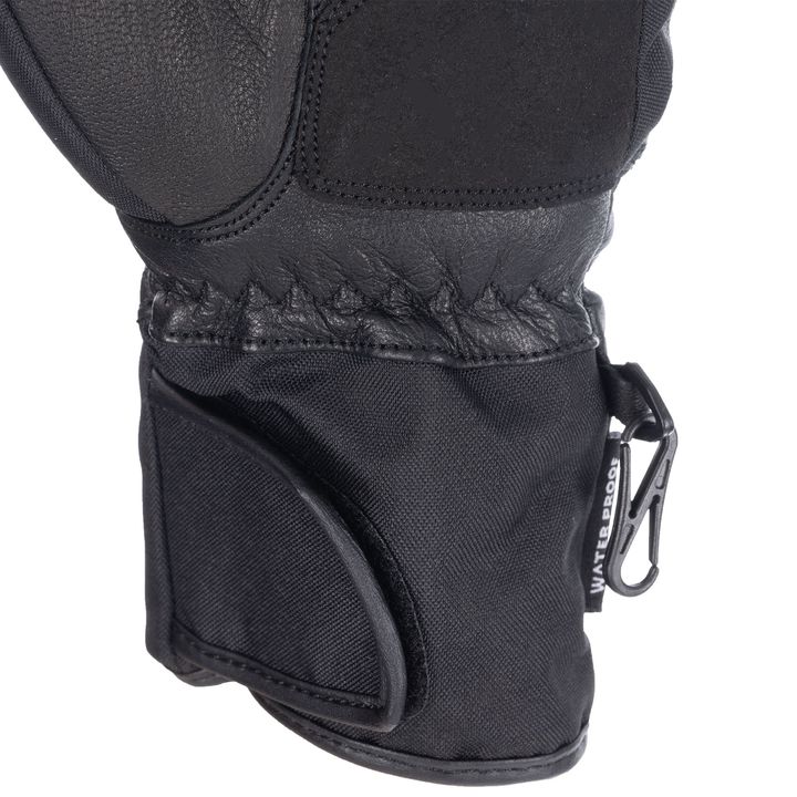 A close-up of a black motorcycle glove with textured grip details and a branded Velcro wrist closure.