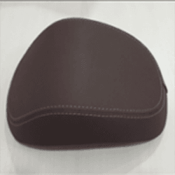 A brown motorcycle seat with white stitching on a light background.