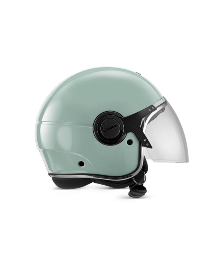 A mint green Vespa motorcycle helmet with a clear visor on a white background.