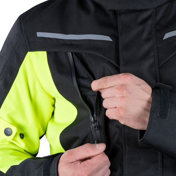 Close-up of a person zipping up a high-visibility black and fluorescent yellow safety jacket with reflective stripes.