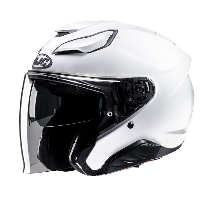 A white motorcycle helmet with a visor, featuring upper ventilation and a brand logo on the forehead area, isolated on a white background.