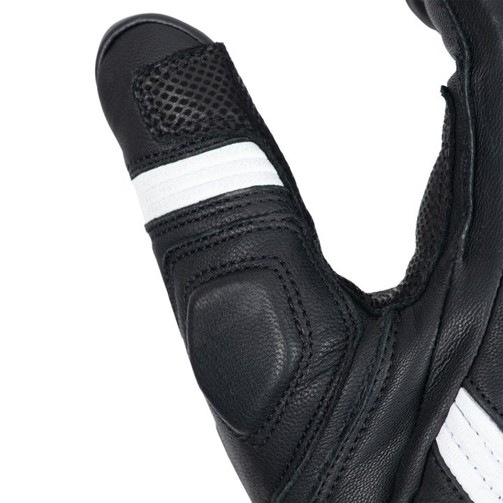 Close-up of a black leather sneaker with a textured toe cap and white stripes on the side.