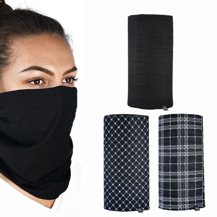 Comfy Black and White Tartan 3-Pack A woman wearing a black neck gaiter covering her nose and mouth with three different designs of neck gaiters displayed to the right: one solid black and two with plaid patterns.